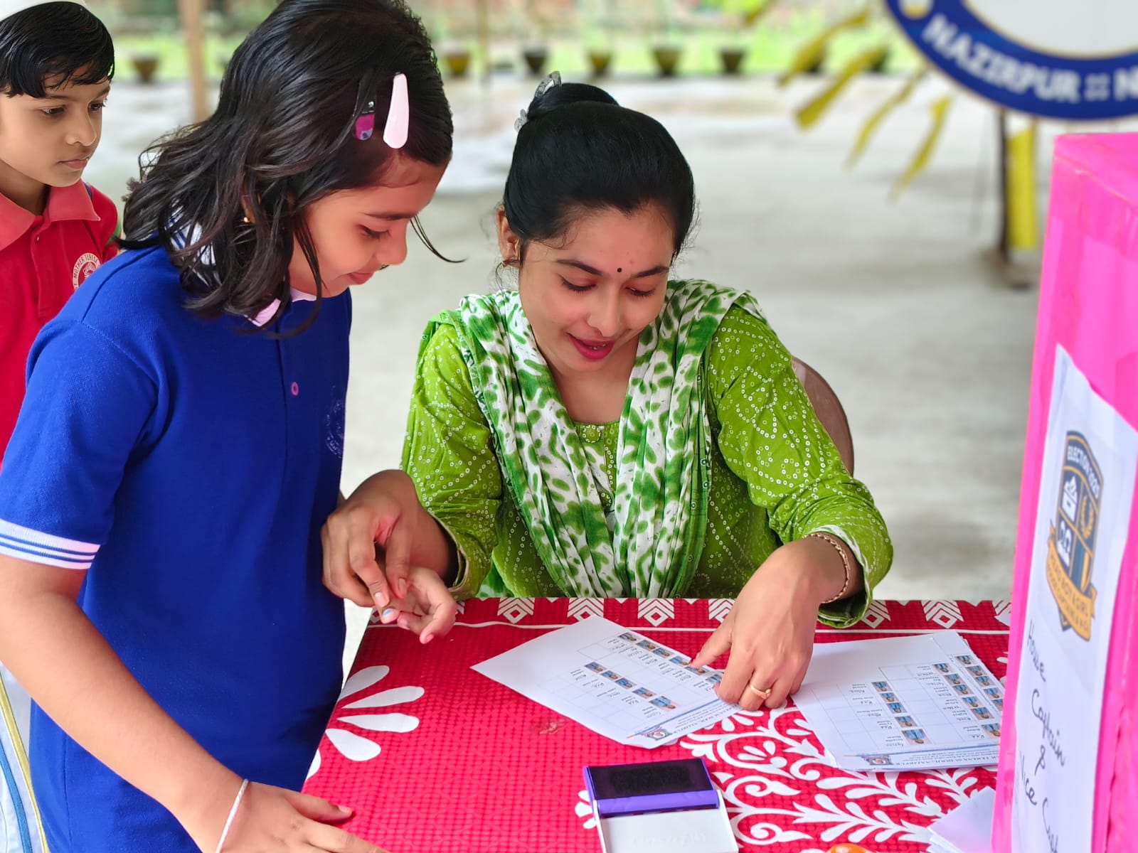 Teacher Assisting Student with Election Ballot